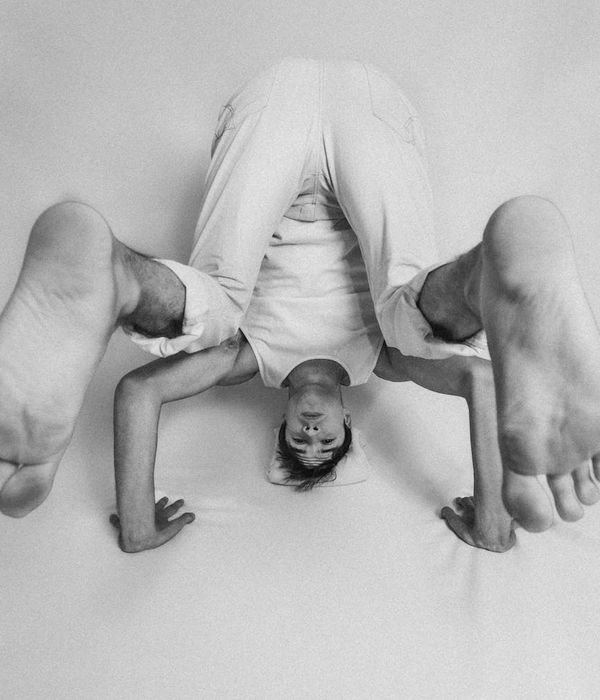 Man performing a controlled strength exercise in a calm studio.